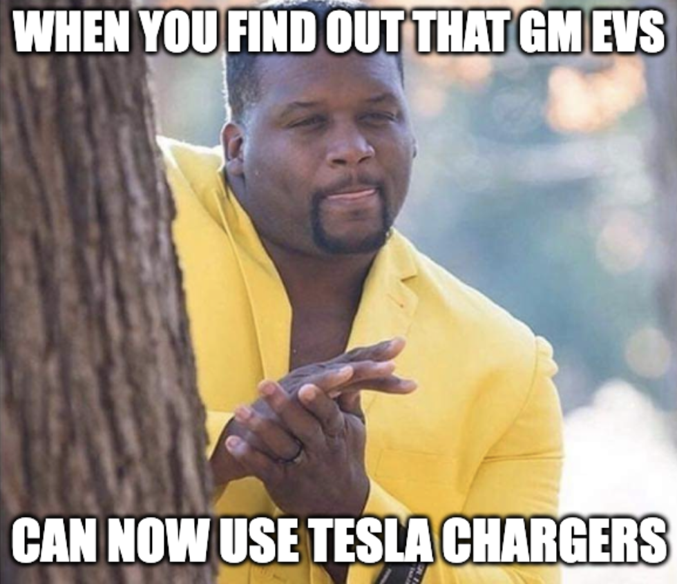 A meme featuring a man rubbing his hands that says, "When you find out that GM EVs can now use Tesla chargers."