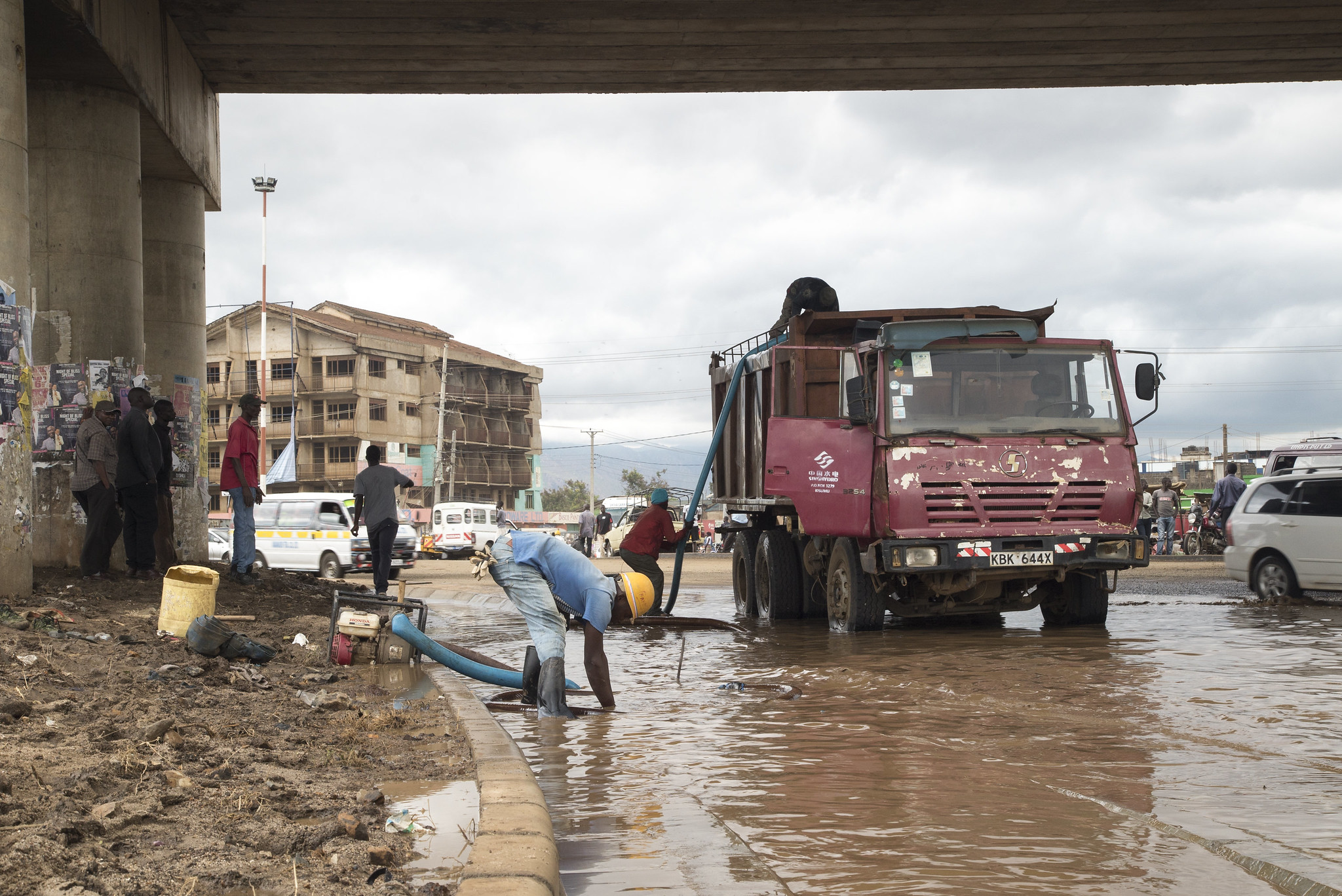 Workers drain a flooded thoroughfare after a night of severe thunderstorms in Kisumu, Kenya. 